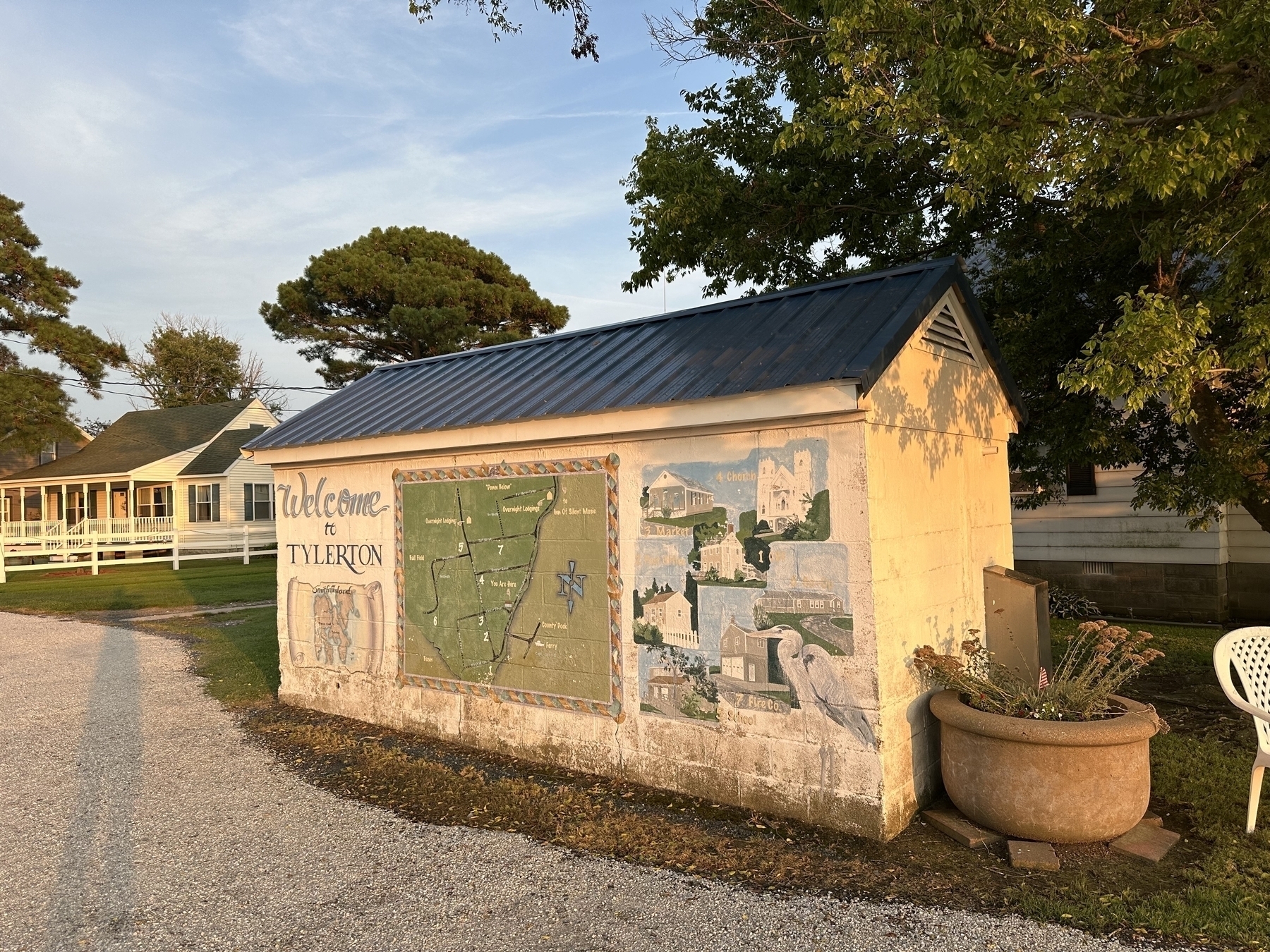 Photo of a shed with “Welcome to Tylerton” and town map painted on the wall.